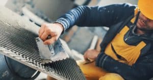 applying adhesive to a tile