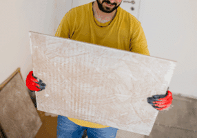 man holding a 12"x12" ceramic tile